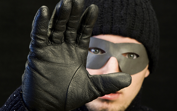 masked-home-burglar-hand-raised