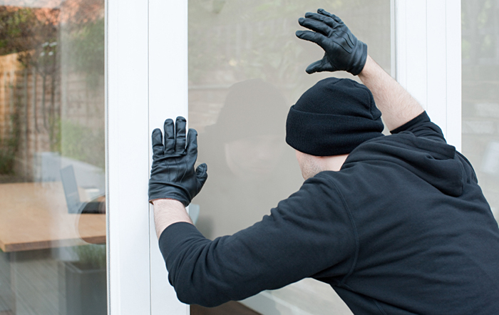 burglar-looking-for-alarm-system