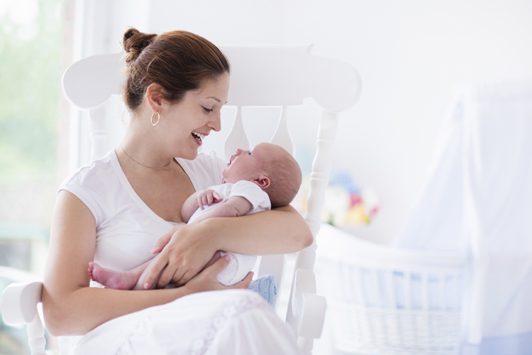 mom-cradling-new-baby-at-home